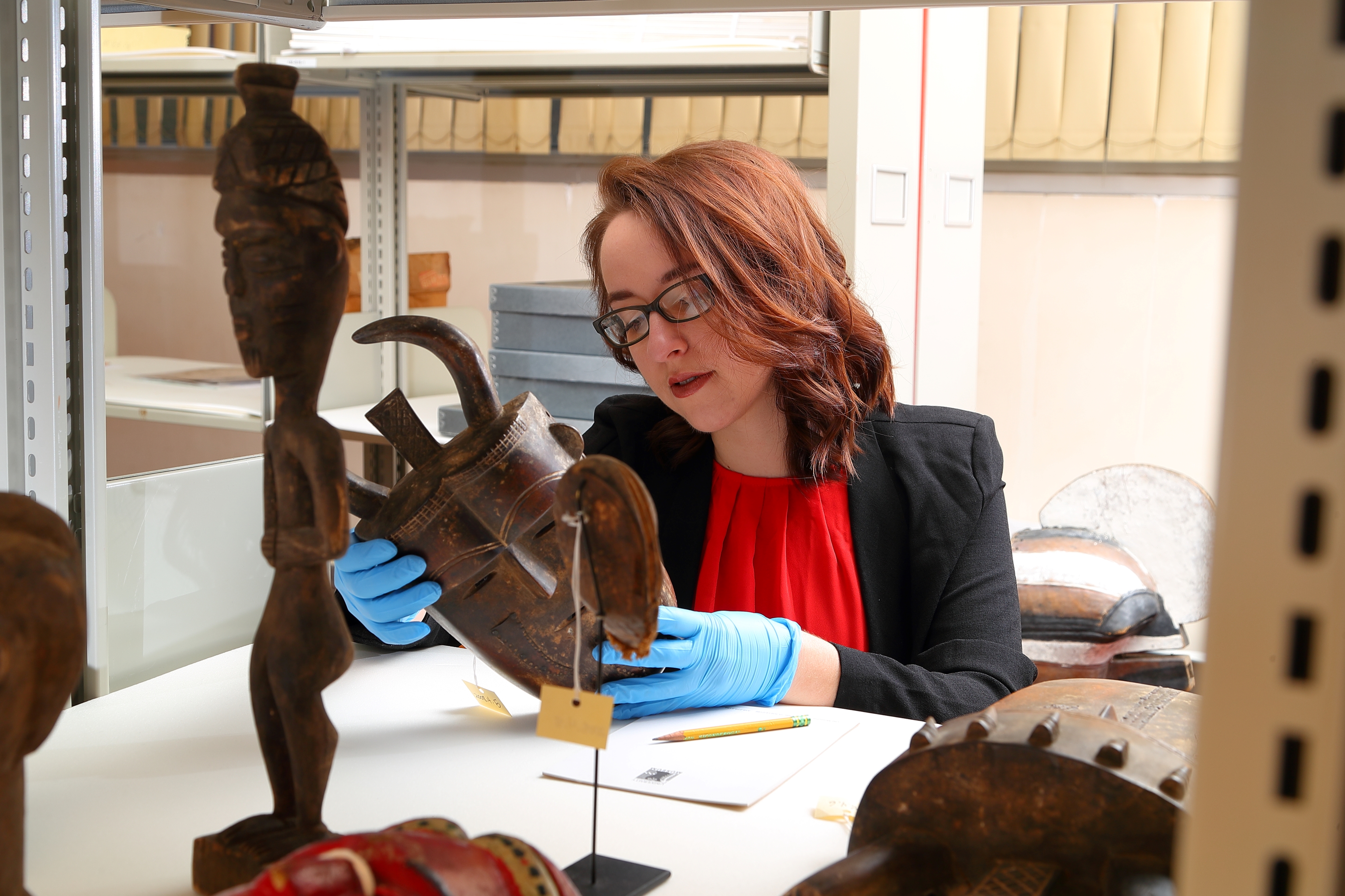 Student examining museum object