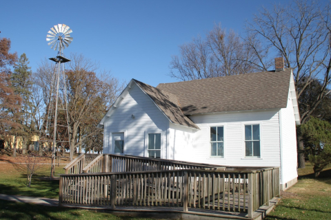 	Alton schoolhouse in 2016 with a wooden ramp in front and windmill to the left