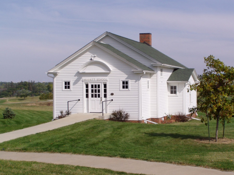 Photo of a white schoolhouse