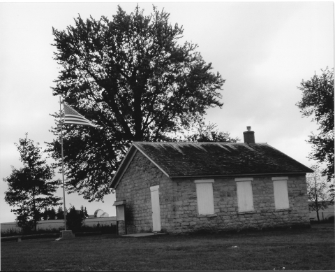 Black and white photo of a stone schoolhouse